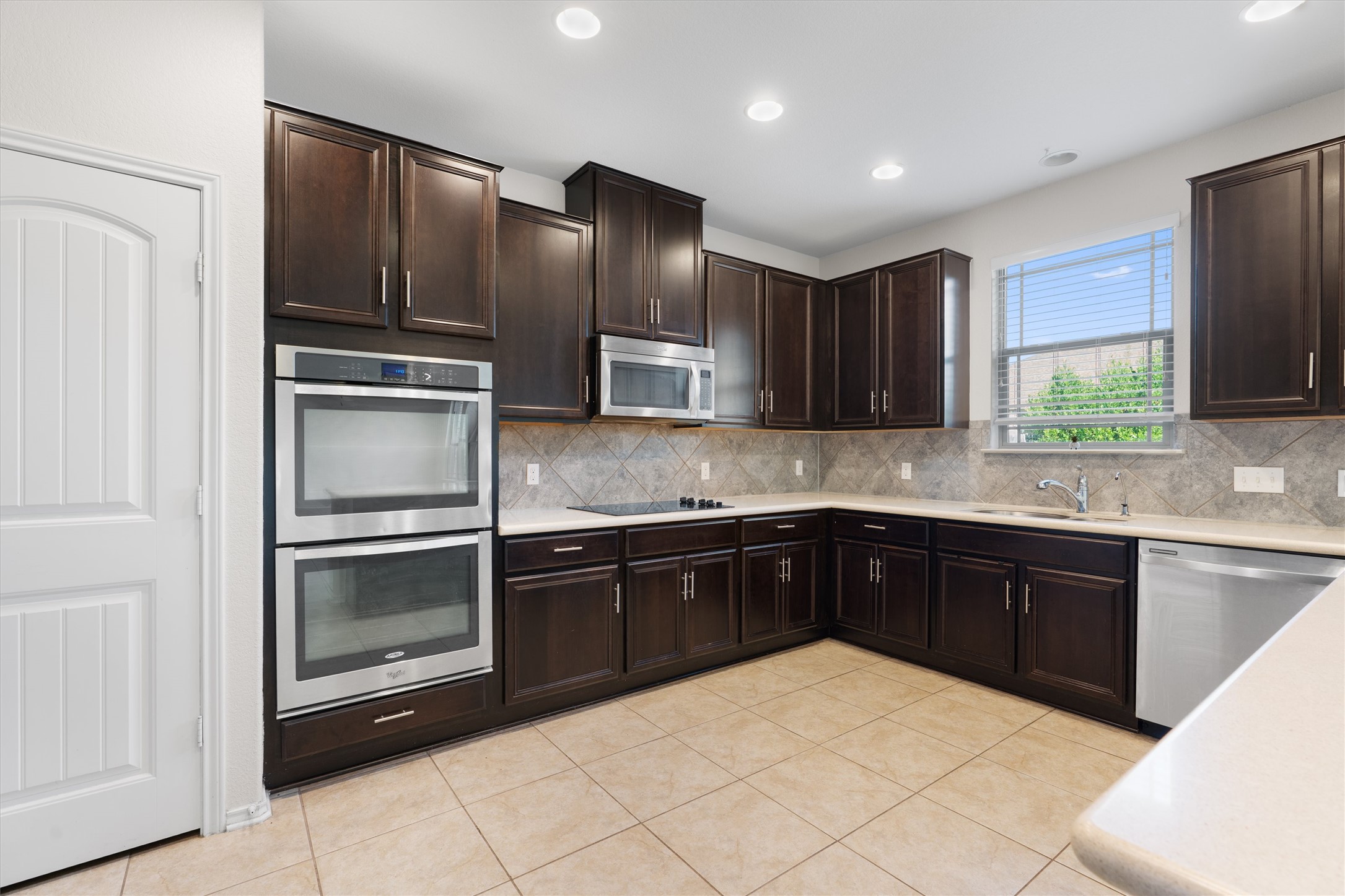 804 Water Hyacinth Loop Leander, TX 78641 - Photo 10 of 37 a kitchen with stainless steel appliances granite countertop a refrigerator and sink