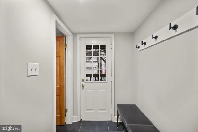 a view of a hallway with wooden floor and entryway