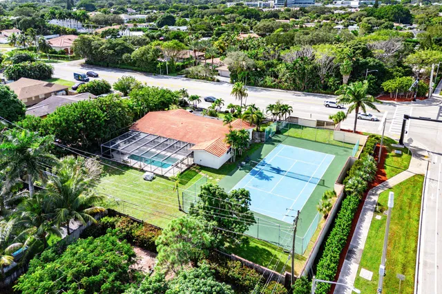 an aerial view of a house with a yard basket ball court and outdoor seating
