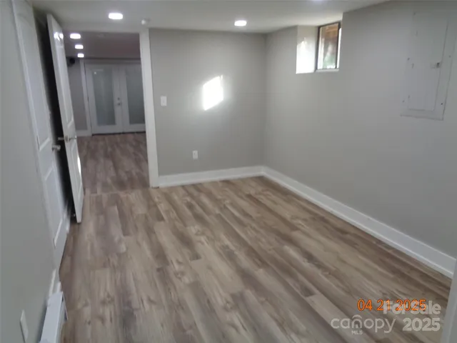 a view of a hallway with wooden shelves