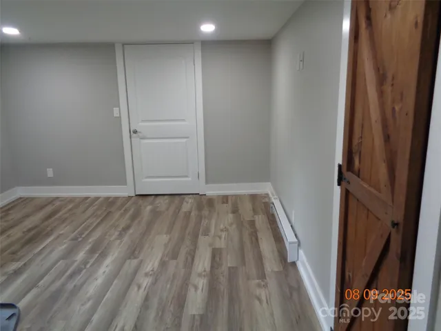 an aerial view of residential house with outdoor space and trees all around