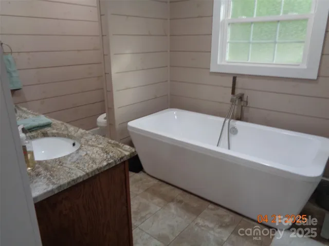 a bathroom with a bathtub and shower