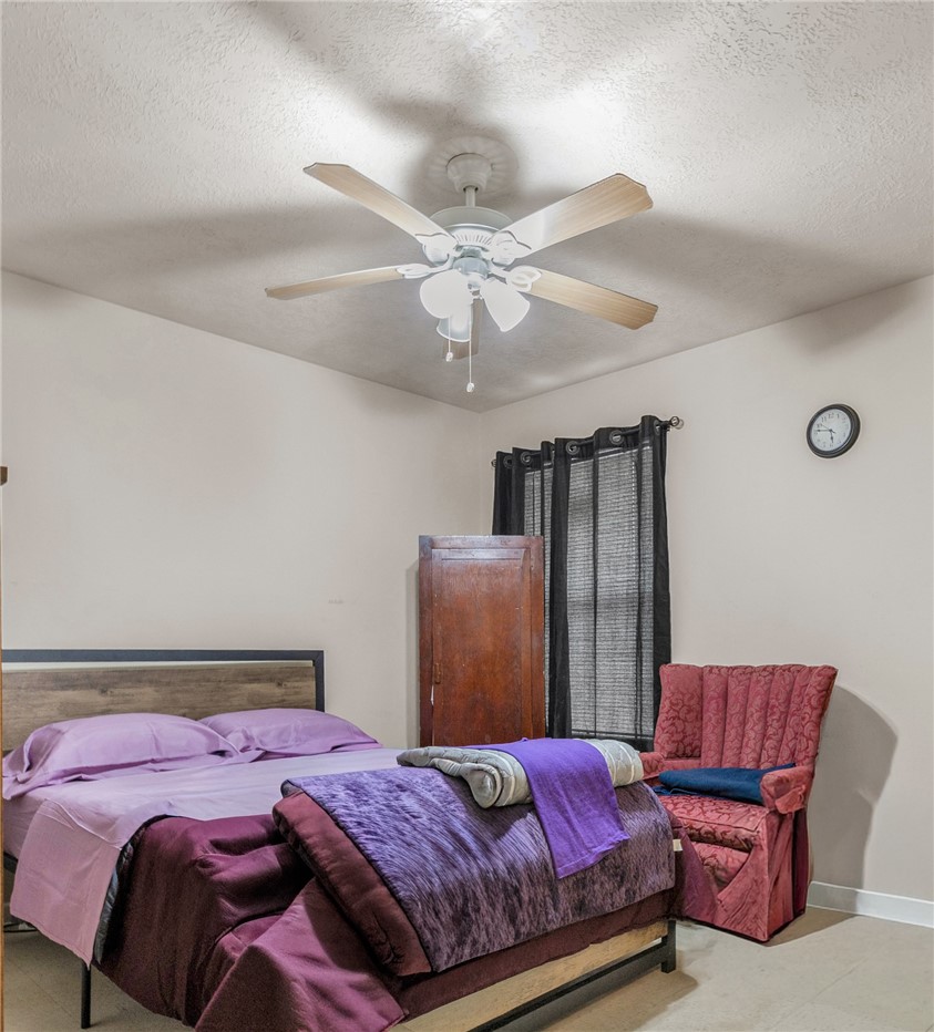 1009 West 17th Street Bryan, TX 77803 - Photo 11 of 11 a bedroom with a bed and a chandelier