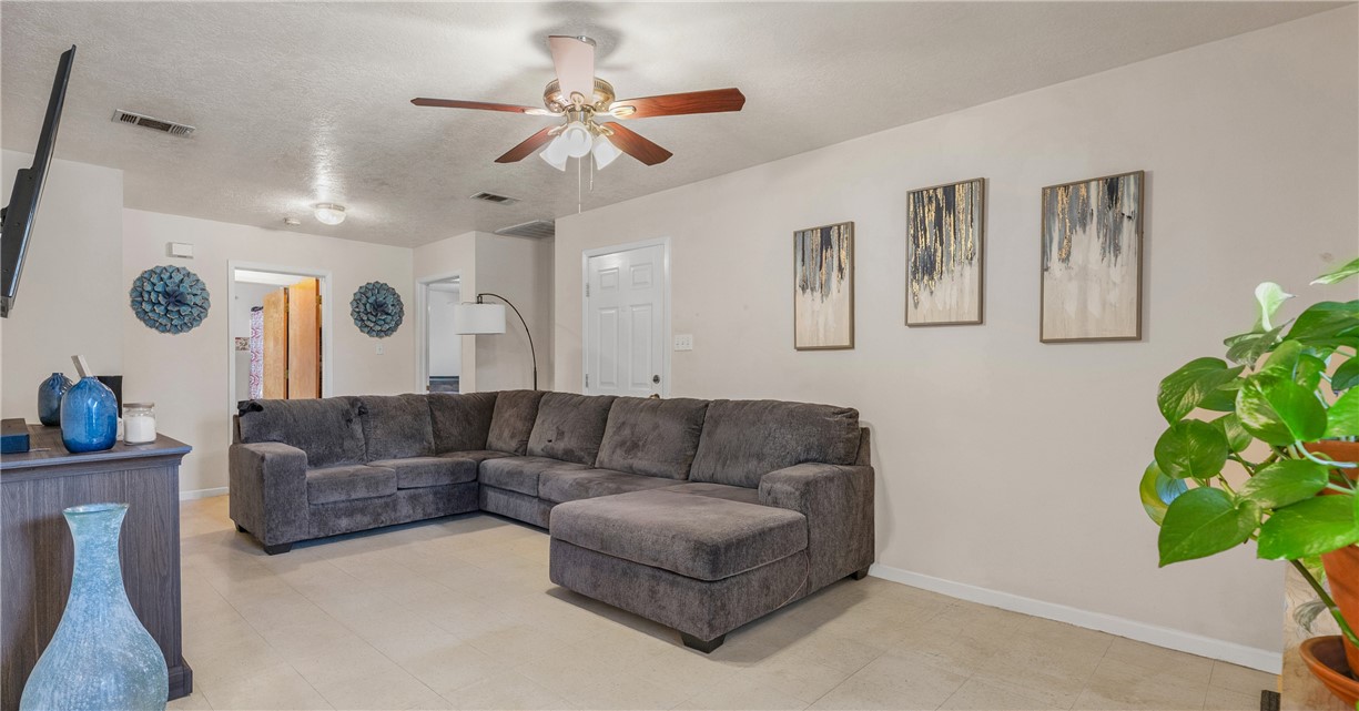 1009 West 17th Street Bryan, TX 77803 - Photo 3 of 11 a living room with furniture and a potted plant