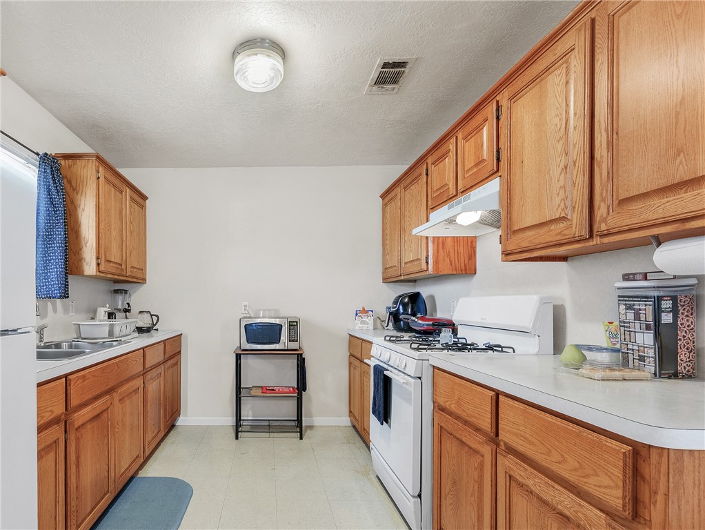 1009 West 17th Street Bryan, TX 77803 - Photo 6 of 11 a kitchen with a sink cabinets and window