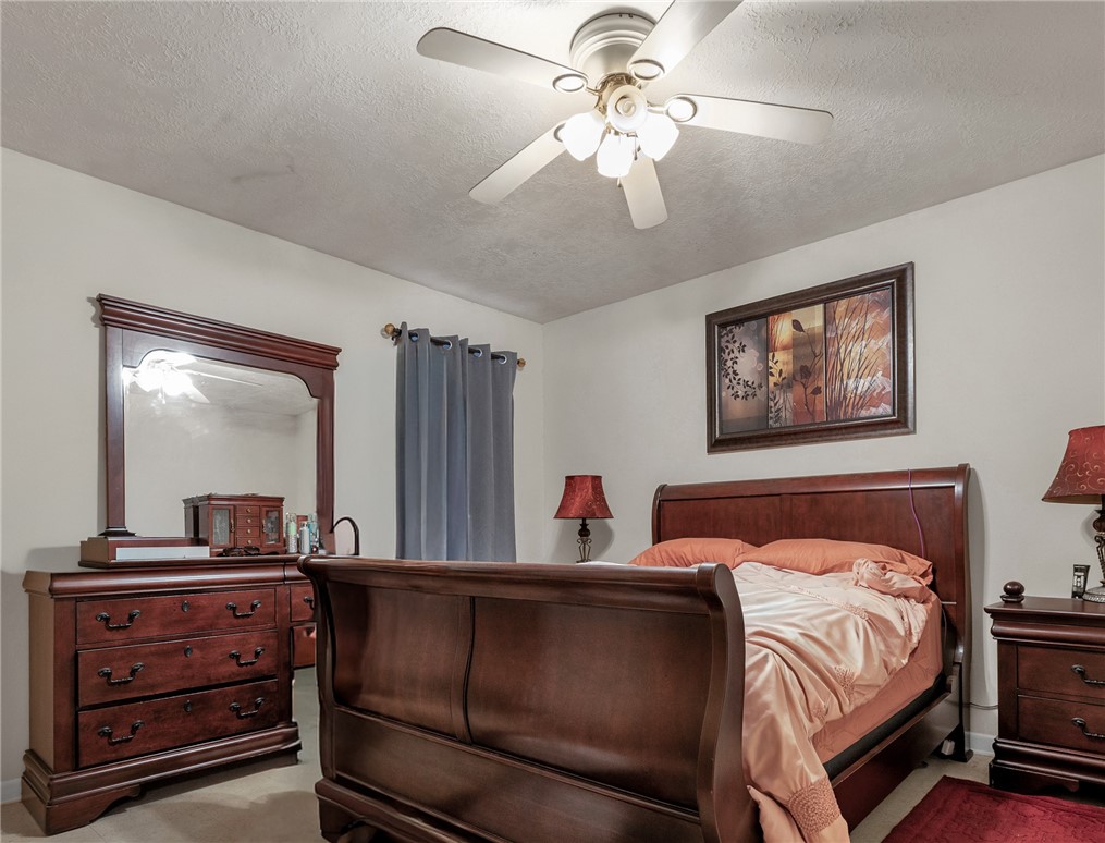 1009 West 17th Street Bryan, TX 77803 - Photo 9 of 11 a bedroom with a bed and a chandelier
