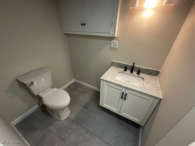586 Ingalls Road Akron, OH 44312 - Photo 20 of 21 Half bath featuring vanity and dark tile patterned flooring