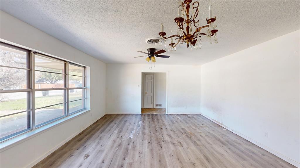 2309 Terrell Road Greenville, TX 75402 - Photo 15 of 30 wooden floor in an empty room with a window