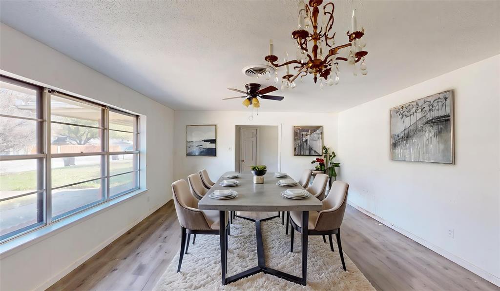 2309 Terrell Road Greenville, TX 75402 - Photo 16 of 30 a view of a dining room with furniture a chandelier and wooden floor
