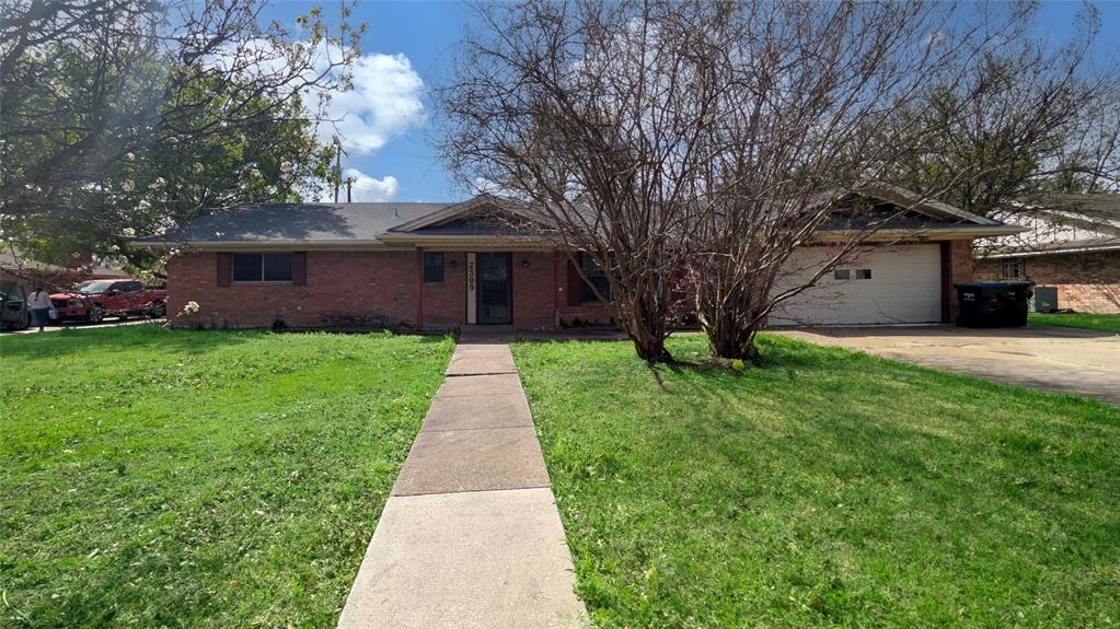 2309 Terrell Road Greenville, TX 75402 - Photo 2 of 30 a front view of house with yard and green space