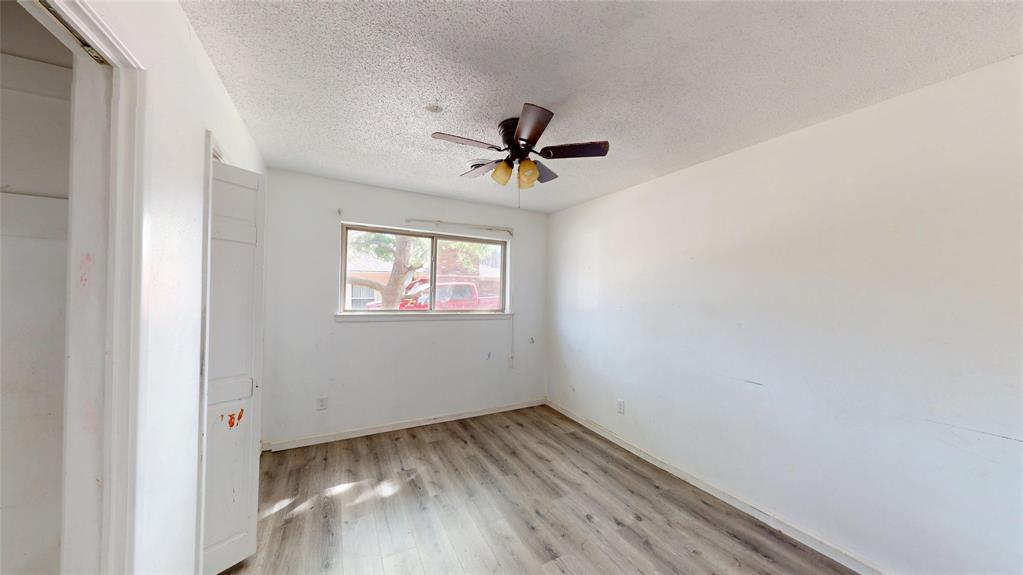 2309 Terrell Road Greenville, TX 75402 - Photo 26 of 30 an empty room with a window and a ceiling fan