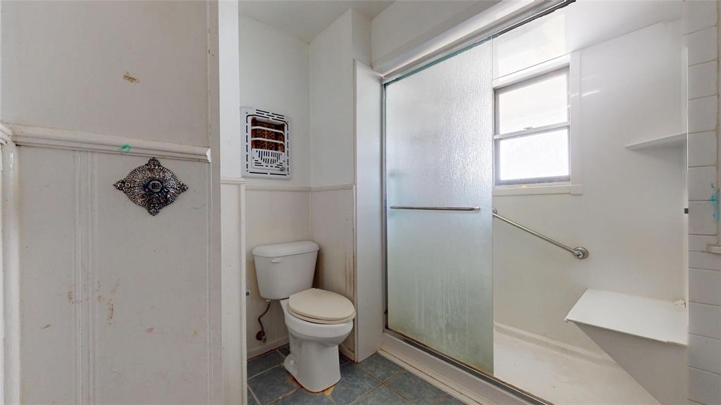 2309 Terrell Road Greenville, TX 75402 - Photo 27 of 30 a white toilet sitting next to a bathroom sink