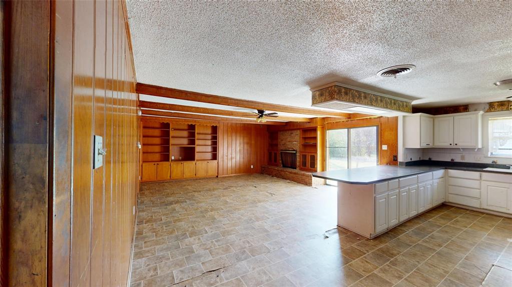 2309 Terrell Road Greenville, TX 75402 - Photo 8 of 30 a kitchen with stainless steel appliances granite countertop a sink and cabinets