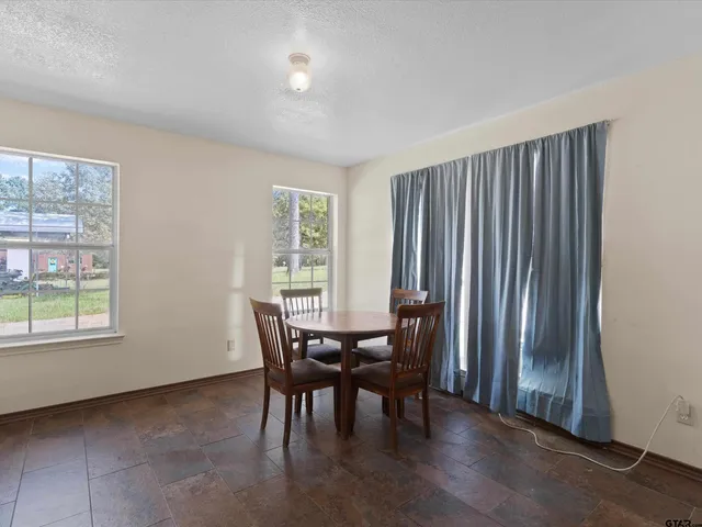 a view of a dining room with furniture and window