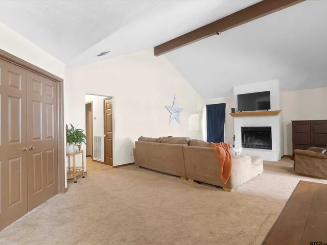 a living room with furniture a fireplace and a flat screen tv