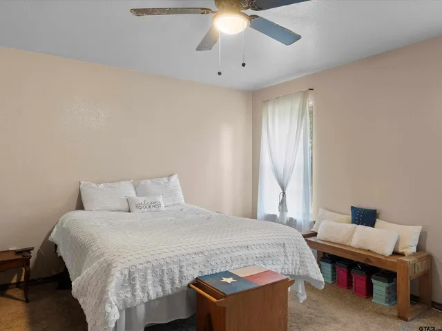 a bed room with a bed and a chandelier