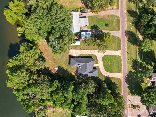 an aerial view of a house with a yard and garden