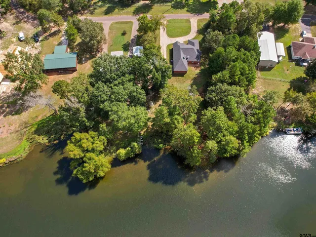 an aerial view of residential house with outdoor space and swimming pool
