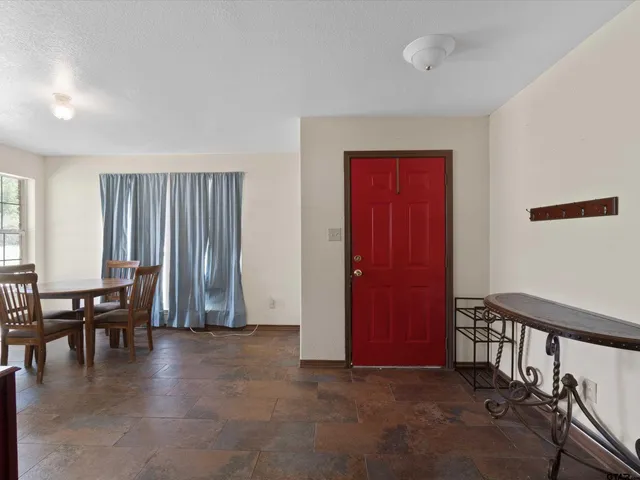 a view of empty room with furniture and window