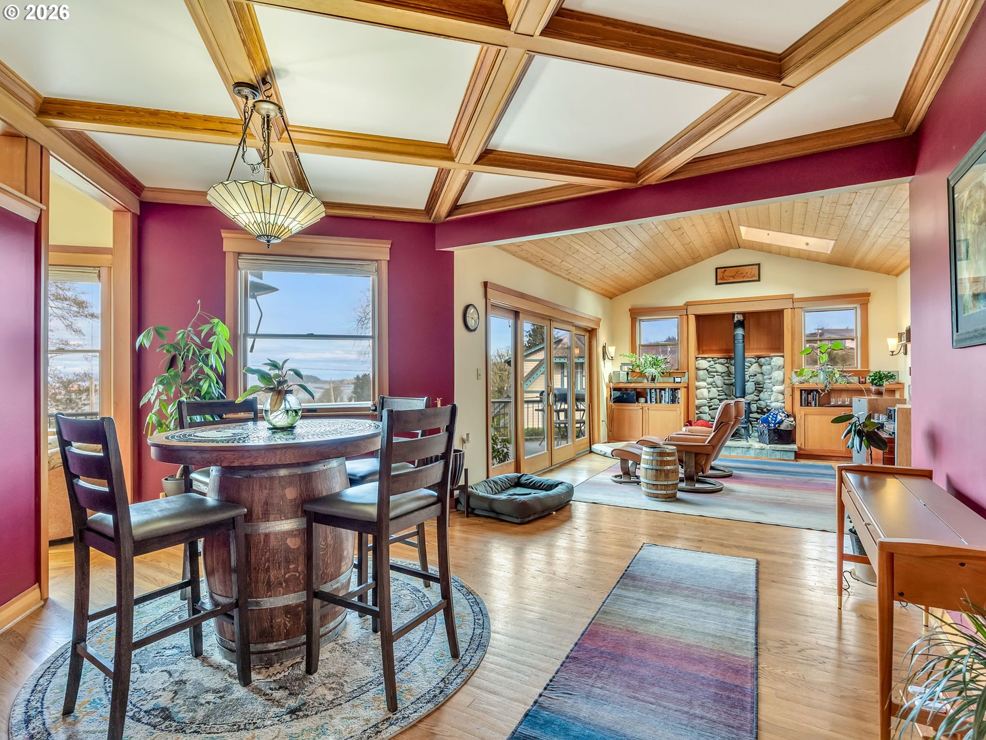 409 2nd Street Astoria, OR 97103 - Photo 14 of 45 a living room with furniture a rug and a chandelier