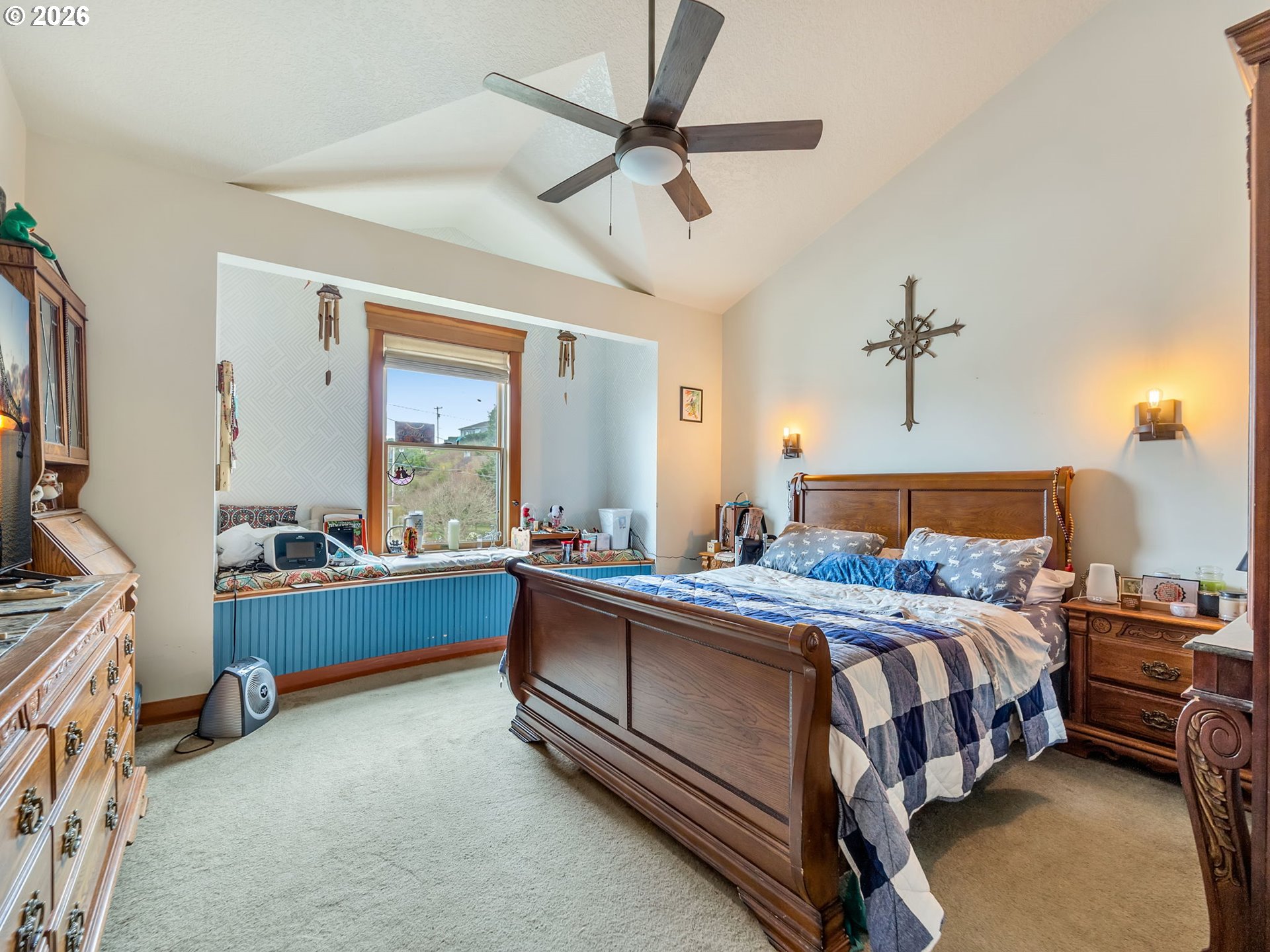 409 2nd Street Astoria, OR 97103 - Photo 20 of 45 a bedroom with a bed and a chandelier