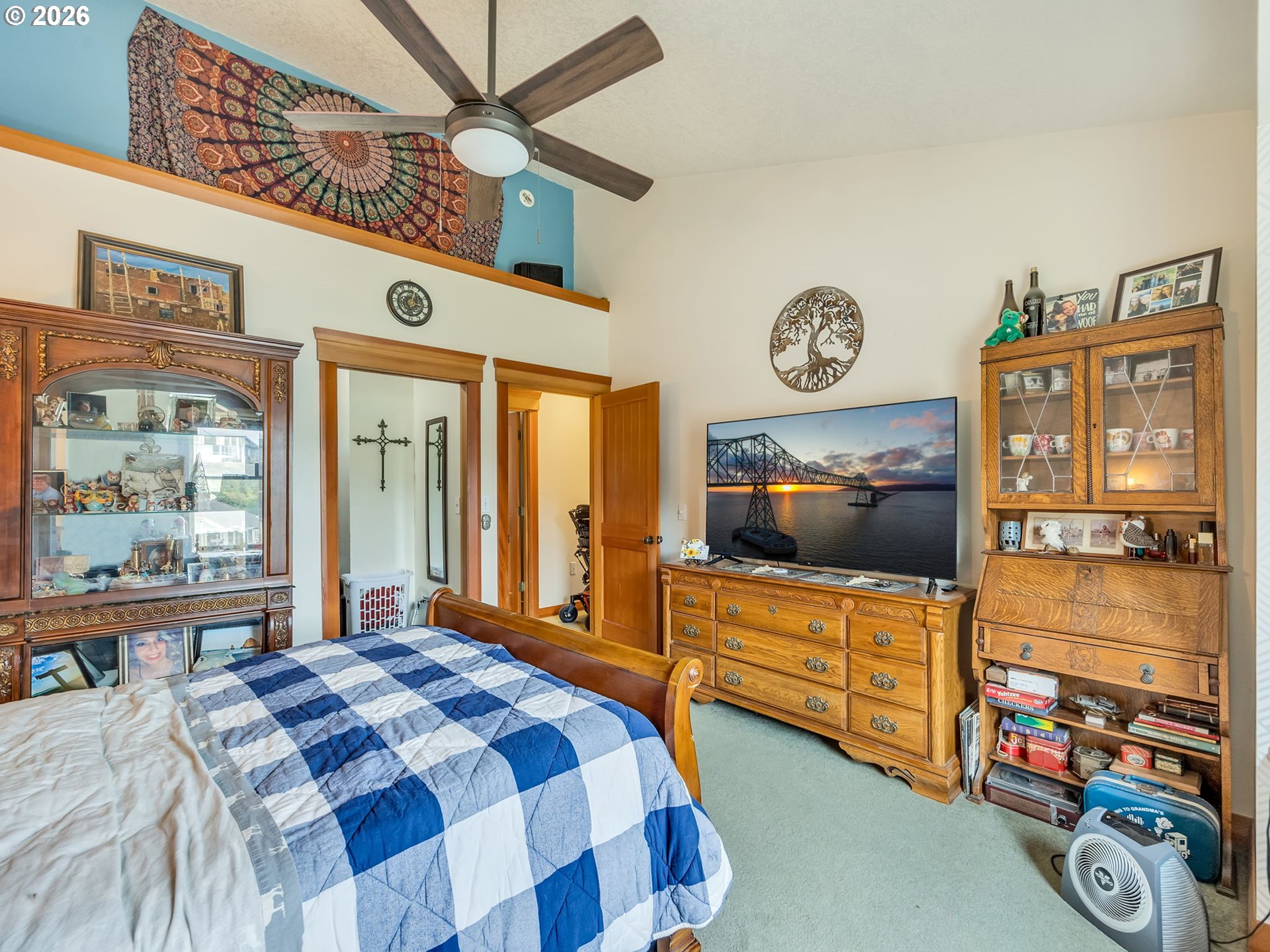 409 2nd Street Astoria, OR 97103 - Photo 21 of 45 a bedroom with a bed a dresser and next to a window