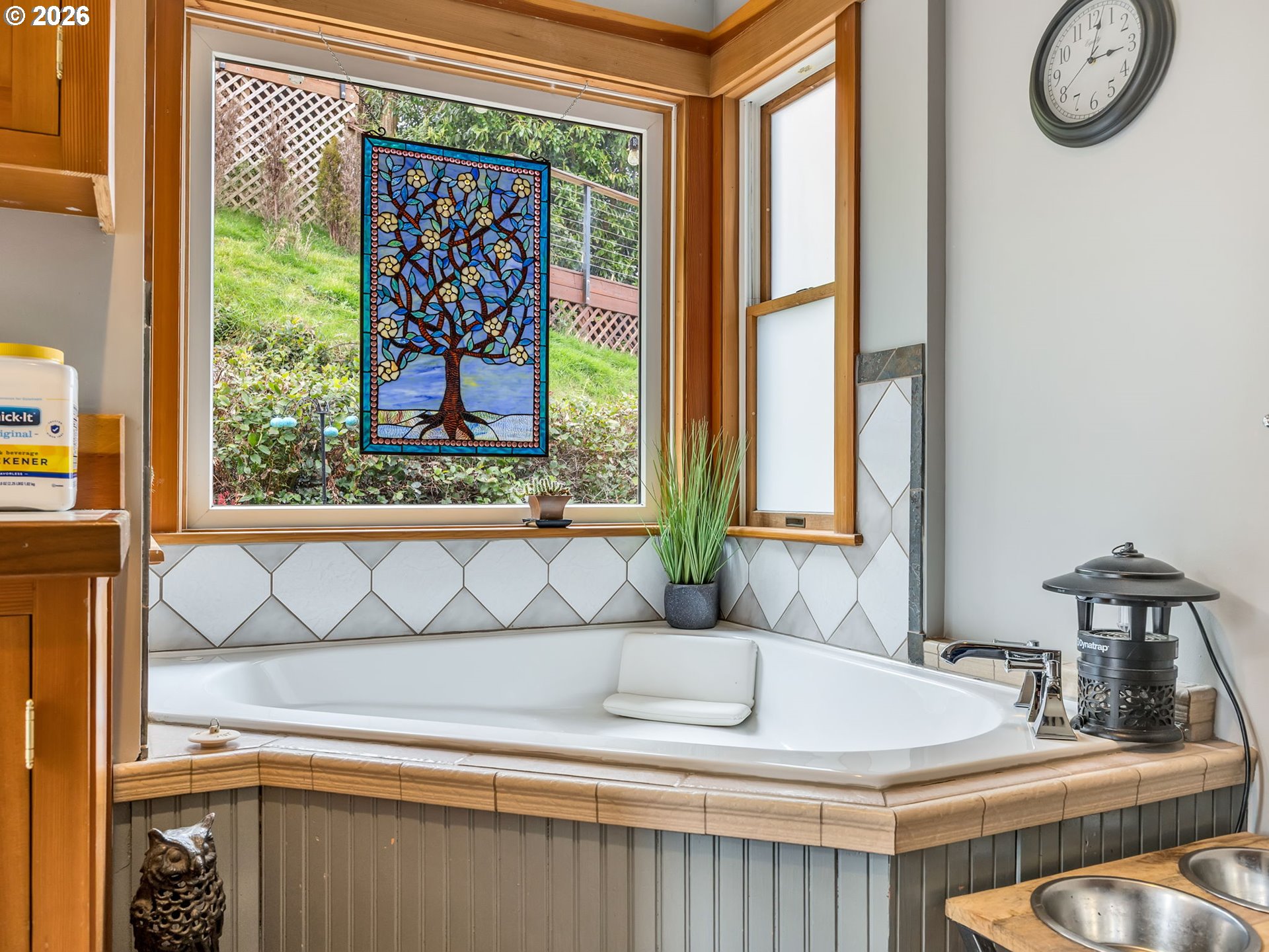 409 2nd Street Astoria, OR 97103 - Photo 25 of 45 a bathroom with a granite countertop sink and a large mirror next to a window