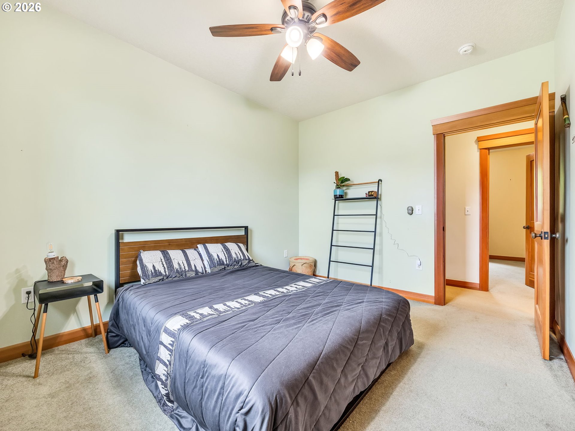 409 2nd Street Astoria, OR 97103 - Photo 29 of 45 a bedroom with a bed and a chandelier