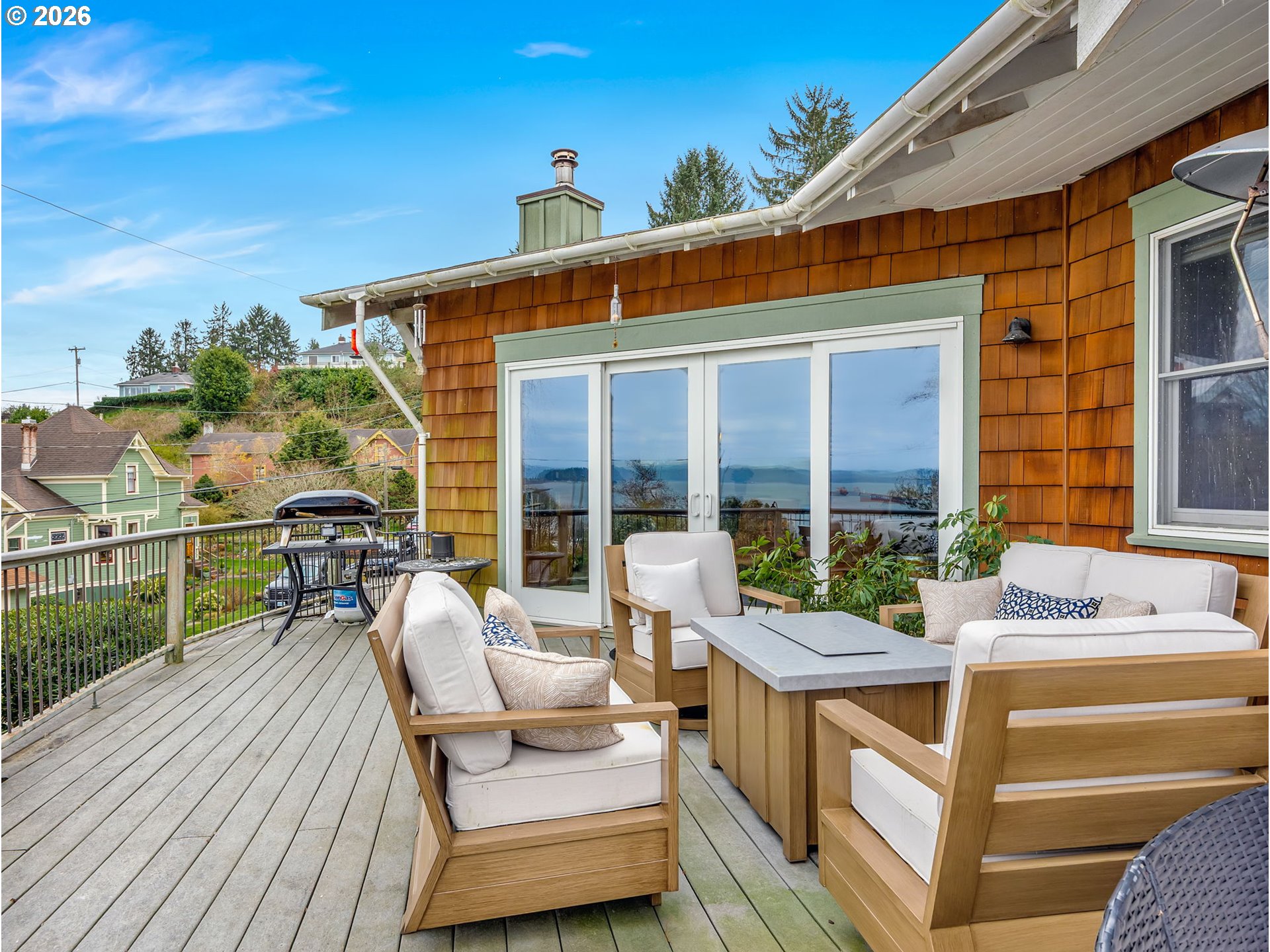 409 2nd Street Astoria, OR 97103 - Photo 45 of 45 a view of a patio with couches table and chairs with wooden floor and fence