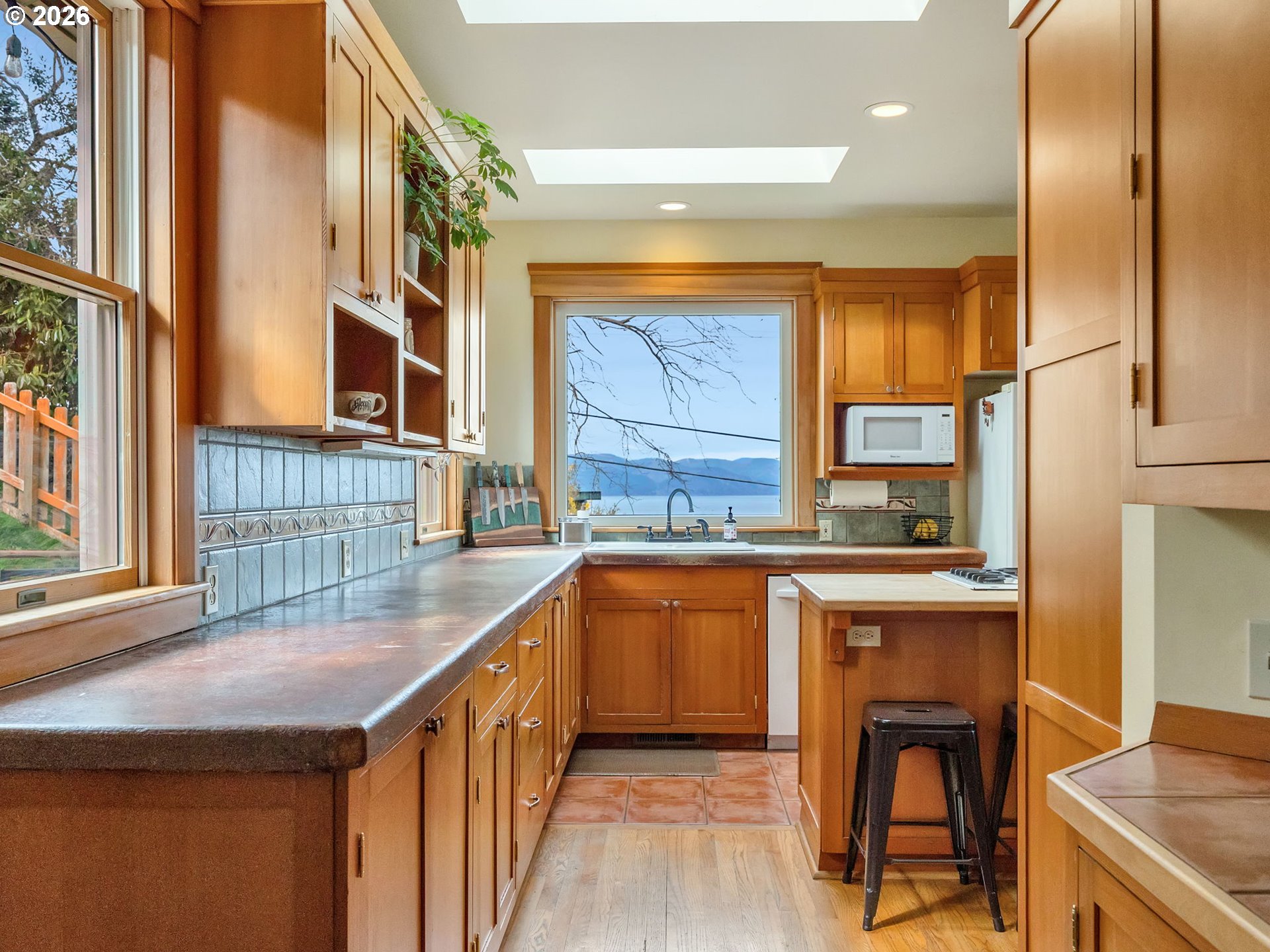 409 2nd Street Astoria, OR 97103 - Photo 7 of 45 a kitchen with stainless steel appliances granite countertop wooden cabinets a sink and a stove