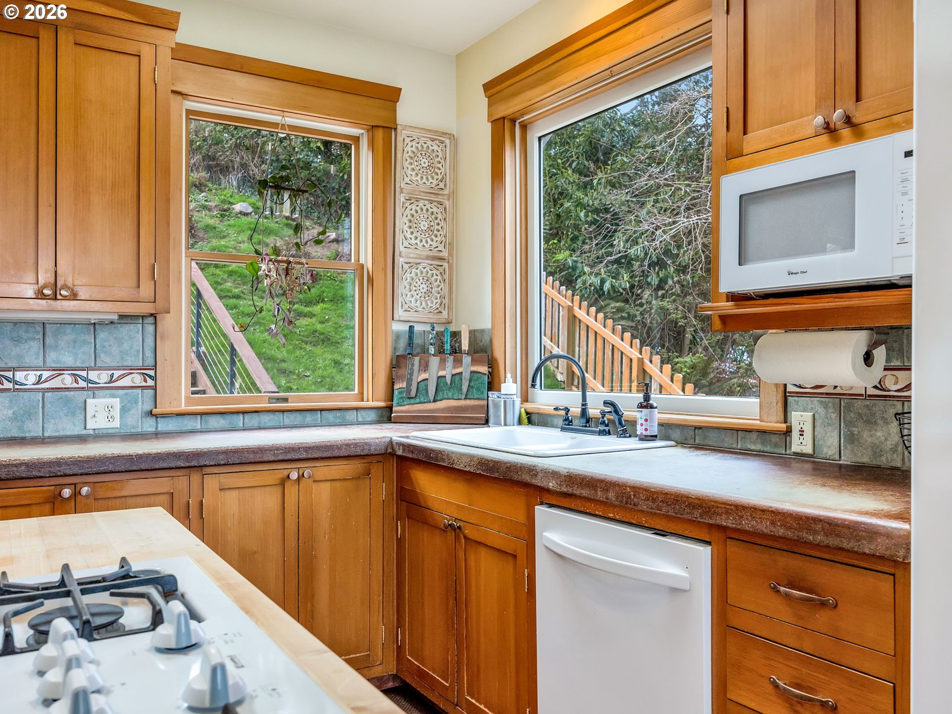409 2nd Street Astoria, OR 97103 - Photo 8 of 45 a kitchen with stainless steel appliances a sink and a window