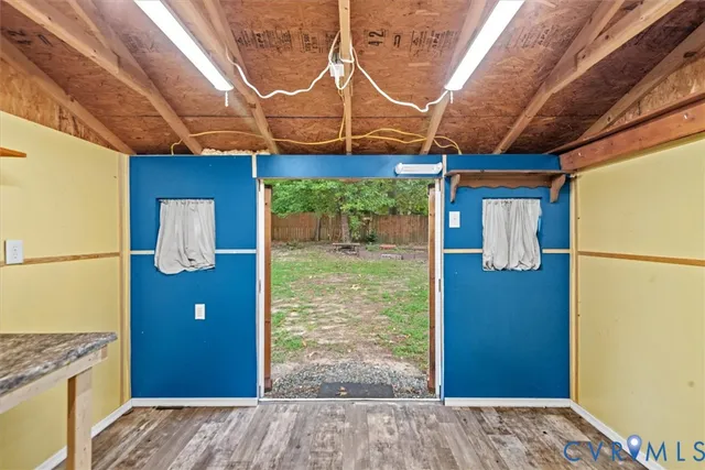 a view of a door and wooden floor