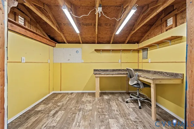 a view of a room with wooden floor