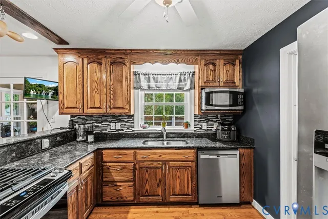 a kitchen with sink a window and appliances