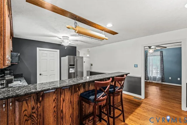 a dining room with furniture and wooden floor