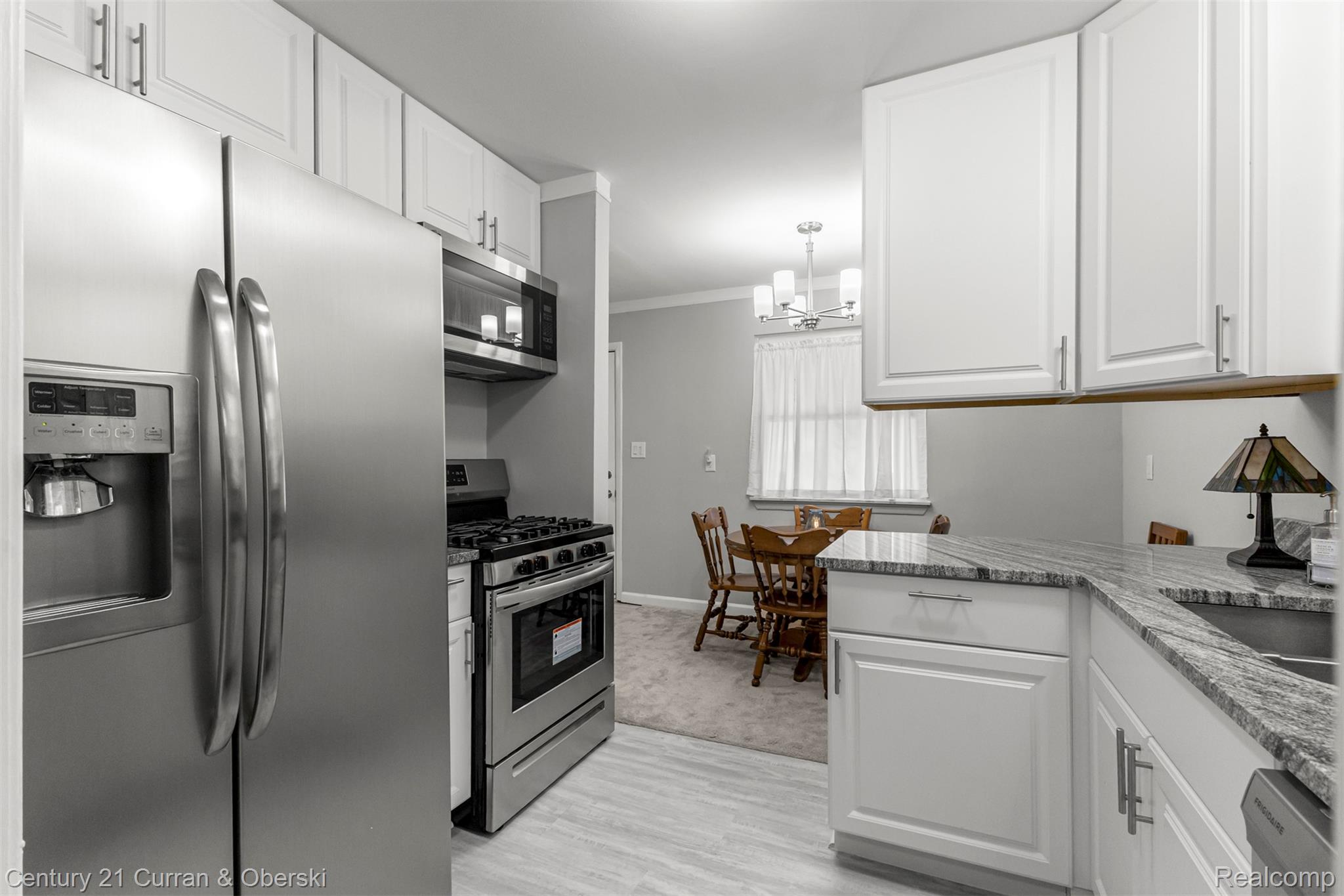 7120 Jackson Street Taylor, MI 48180 - Photo 17 of 24 Kitchen featuring appliances with stainless steel finishes, white cabinetry, light stone counters, and ornamental molding