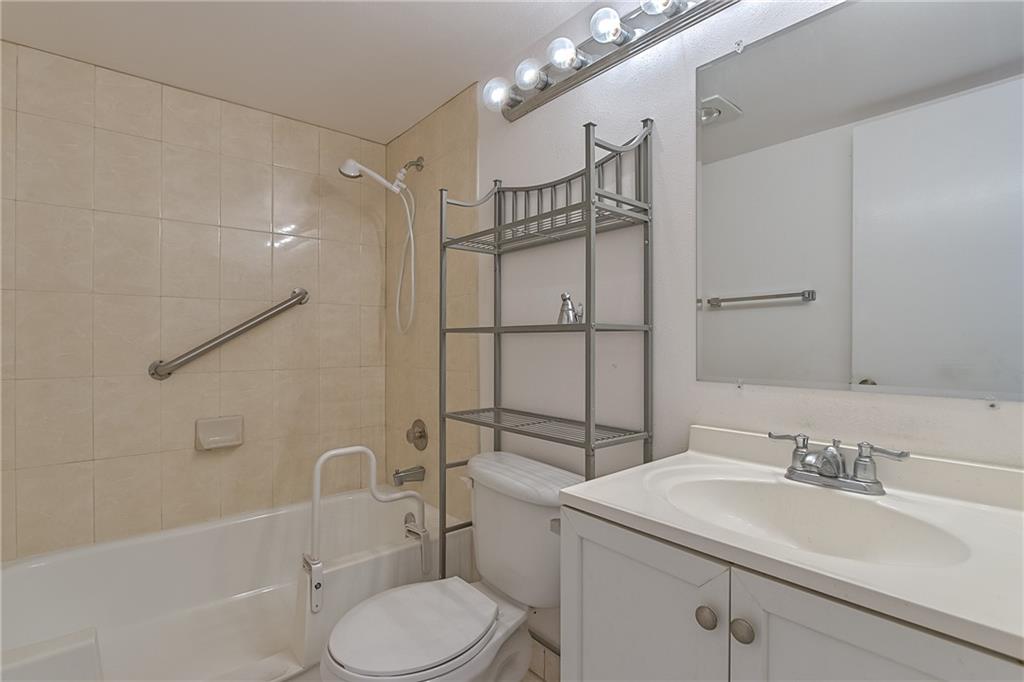 167 Grantham East, Unit 167 Deerfield Beach, FL 33442 - Photo 15 of 20 a bathroom with a sink toilet vanity and shower