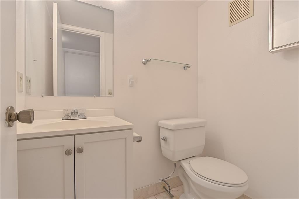 167 Grantham East, Unit 167 Deerfield Beach, FL 33442 - Photo 16 of 20 a bathroom with a toilet a sink and mirror