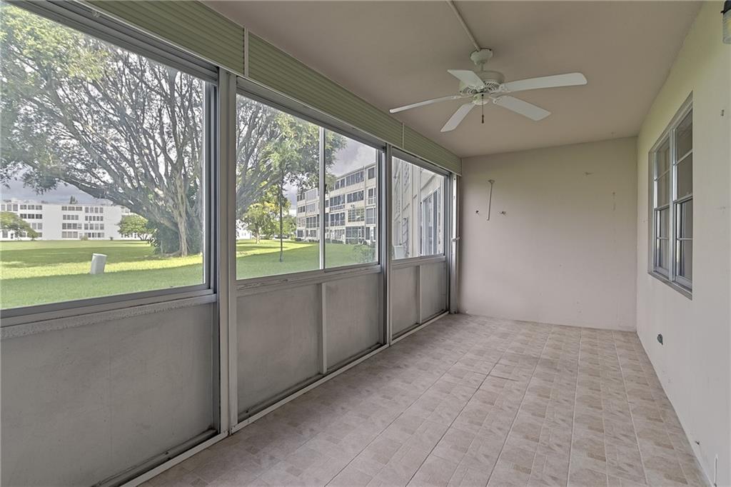 167 Grantham East, Unit 167 Deerfield Beach, FL 33442 - Photo 17 of 20 a view of an empty room with a window and a kitchen