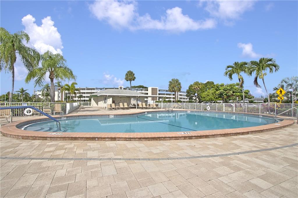 167 Grantham East, Unit 167 Deerfield Beach, FL 33442 - Photo 20 of 20 a view of a swimming pool with a yard