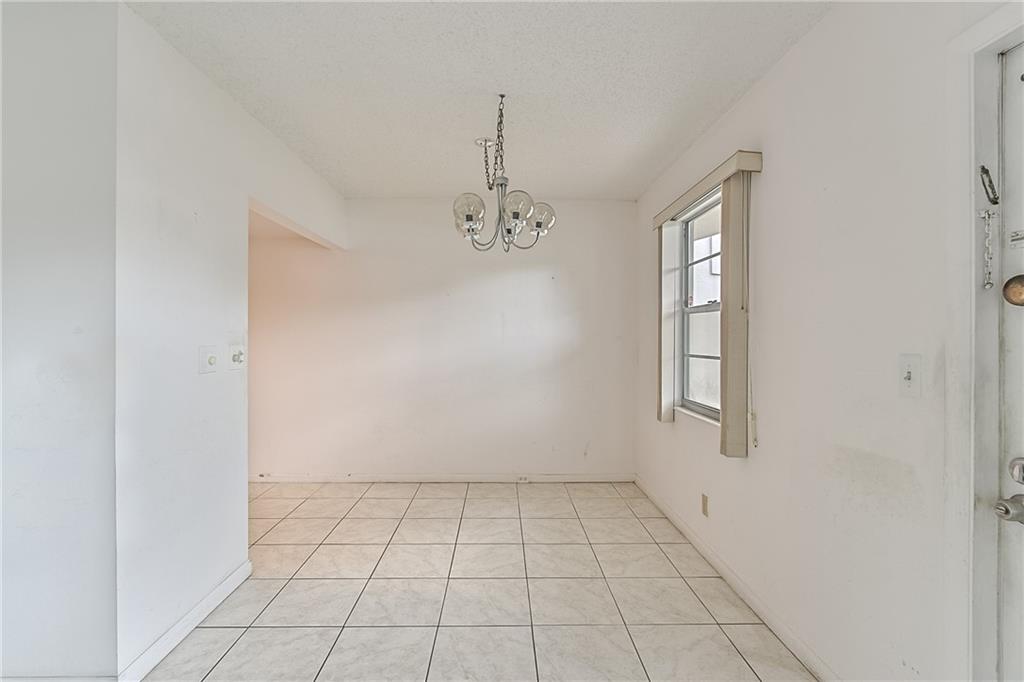 167 Grantham East, Unit 167 Deerfield Beach, FL 33442 - Photo 6 of 20 an empty room with windows