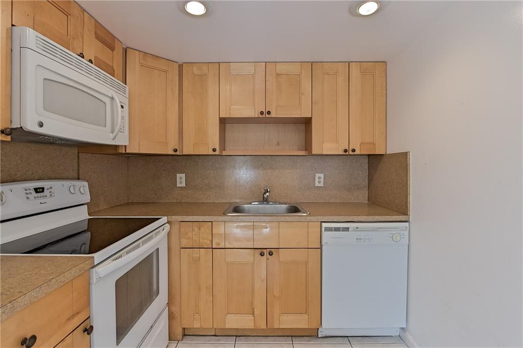 167 Grantham East, Unit 167 Deerfield Beach, FL 33442 - Photo 7 of 20 a kitchen with granite countertop cabinets stainless steel appliances and a sink