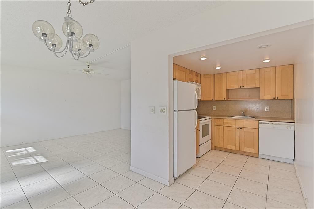 167 Grantham East, Unit 167 Deerfield Beach, FL 33442 - Photo 8 of 20 a kitchen with a refrigerator and a stove top oven