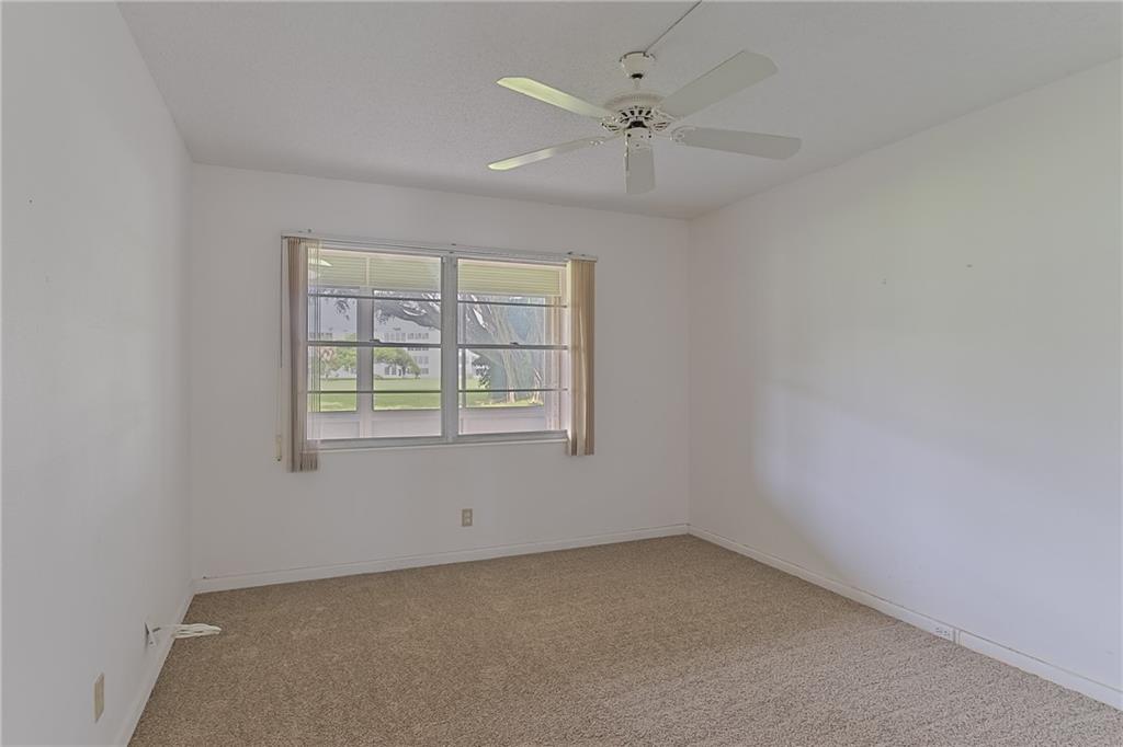 167 Grantham East, Unit 167 Deerfield Beach, FL 33442 - Photo 10 of 20 an empty room with a window and a fan