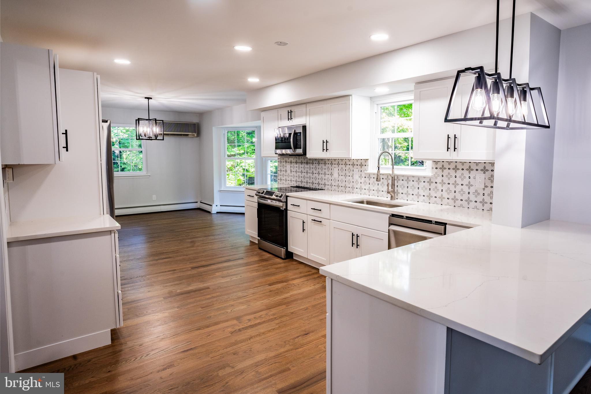 1428 Valley Forge Road Norristown, PA 19403 - Photo 7 of 24 a kitchen with stainless steel appliances a sink a stove a refrigerator cabinets and wooden floor