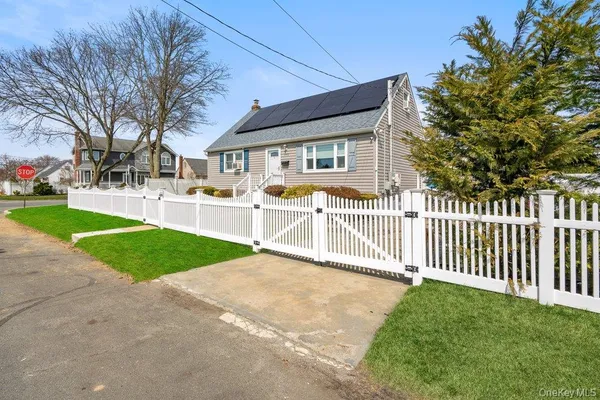 a view of a house with a yard and fence