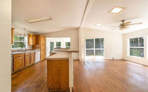 a view of a large kitchen with wooden floor and a sink