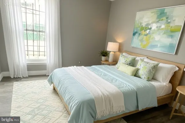 a bedroom with a bed and a painting on the wall
