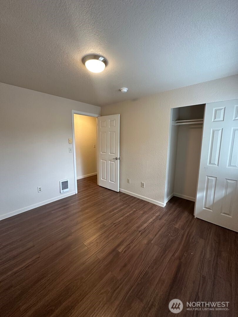 5100 81st Place Southwest, Unit B Mukilteo, WA 98275 - Photo 12 of 12 an empty room with wooden floor and door