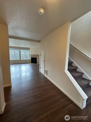 a view of a room with wooden floor